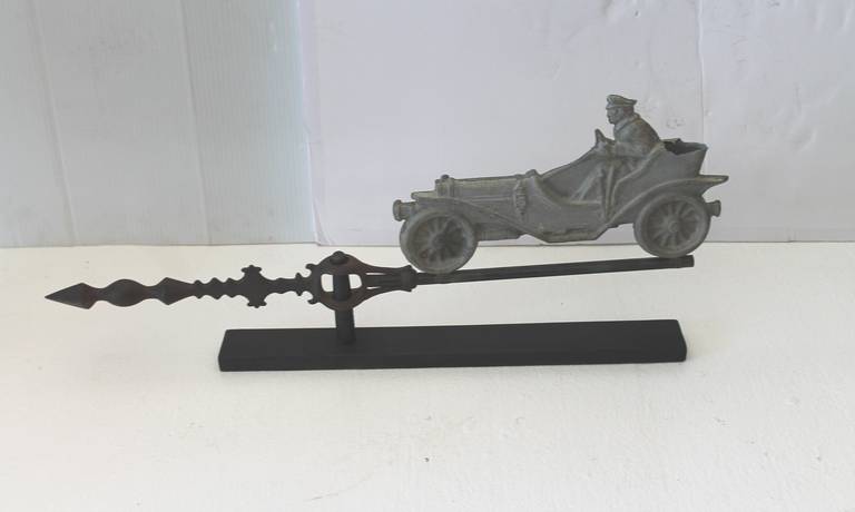 This is a amazing folk art lighting rod and weather vane all  in one. The zink auto and man have a great worn surface with a minor break in the rear of top of car. The cast iron rod and directional is in great condition.The copper rod is a copper
