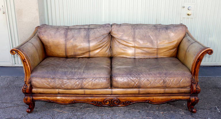 This French hand carved wood and distressed Italian leather sofa has such a fantastic form and look.This large sofa is very comfortable and just so nicely distressed and great looking.The wood frame is very sturdy too.Great looking with Navajo