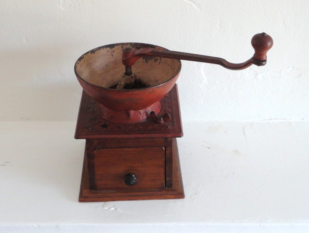This most unusual tabletop coffee grinder has a large cast iron bowl and iron crank handle in salmon paint. The handle is signed 