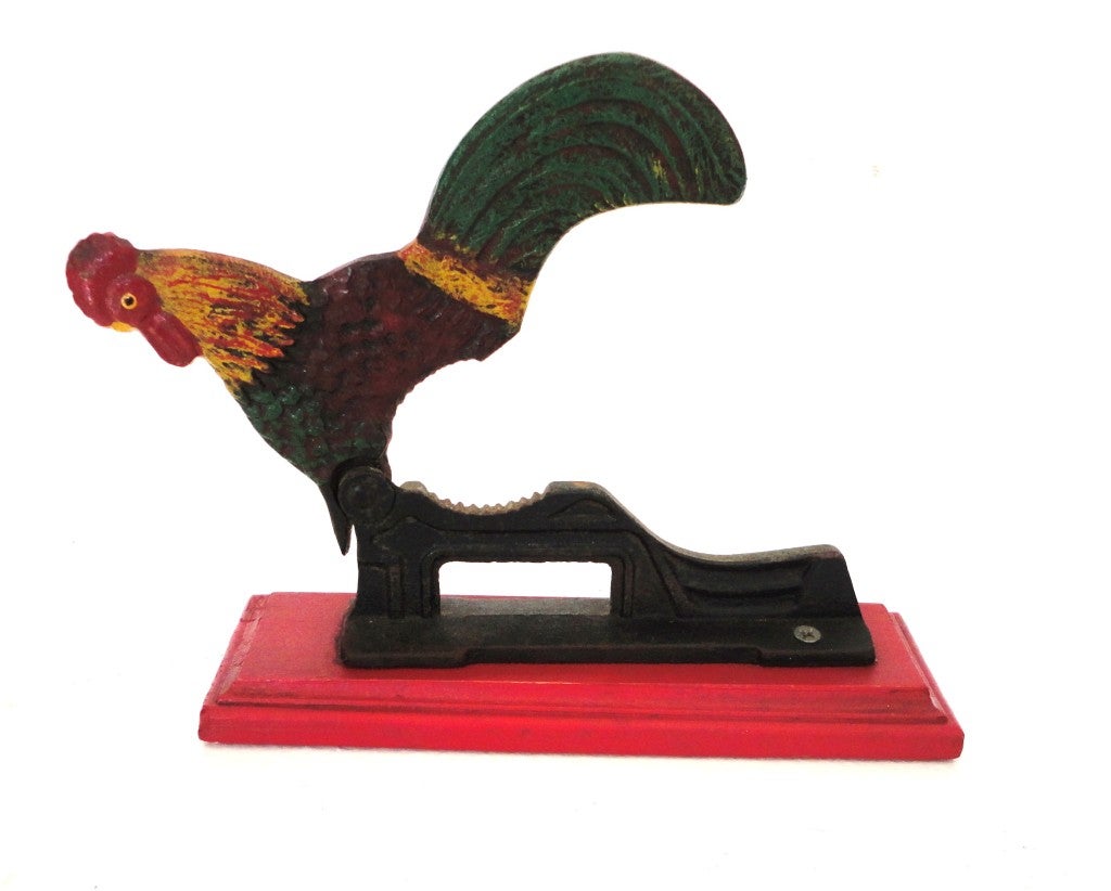 Fantastic and very folky miniature early 20thc original painted rooster nut cracker on the original red painted wood base.This wonderful little nut cracker is a great addition to any folk art collection or on a shelf with other great smalls.This is