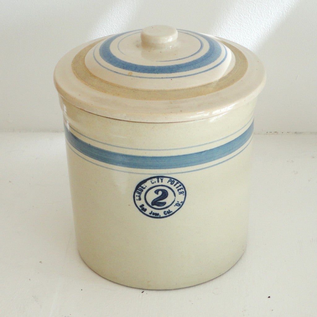 Wonderful pottery canister crock with blue striped lid and base.Signed Garue City Pottery Co. ,San Jose, Cal. and has a large 2 for two gallon.Great canister for in a kitchen.The two pieces are in mint condition.