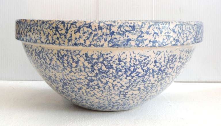 This Robinson Ransbottom spongeware bowl is from the Roseville area of Ohio, circa 1920. This heavy stoneware bowl is decorated in sponged cobalt blue and is strong and durable. At the time these bowls were produced, due to their great