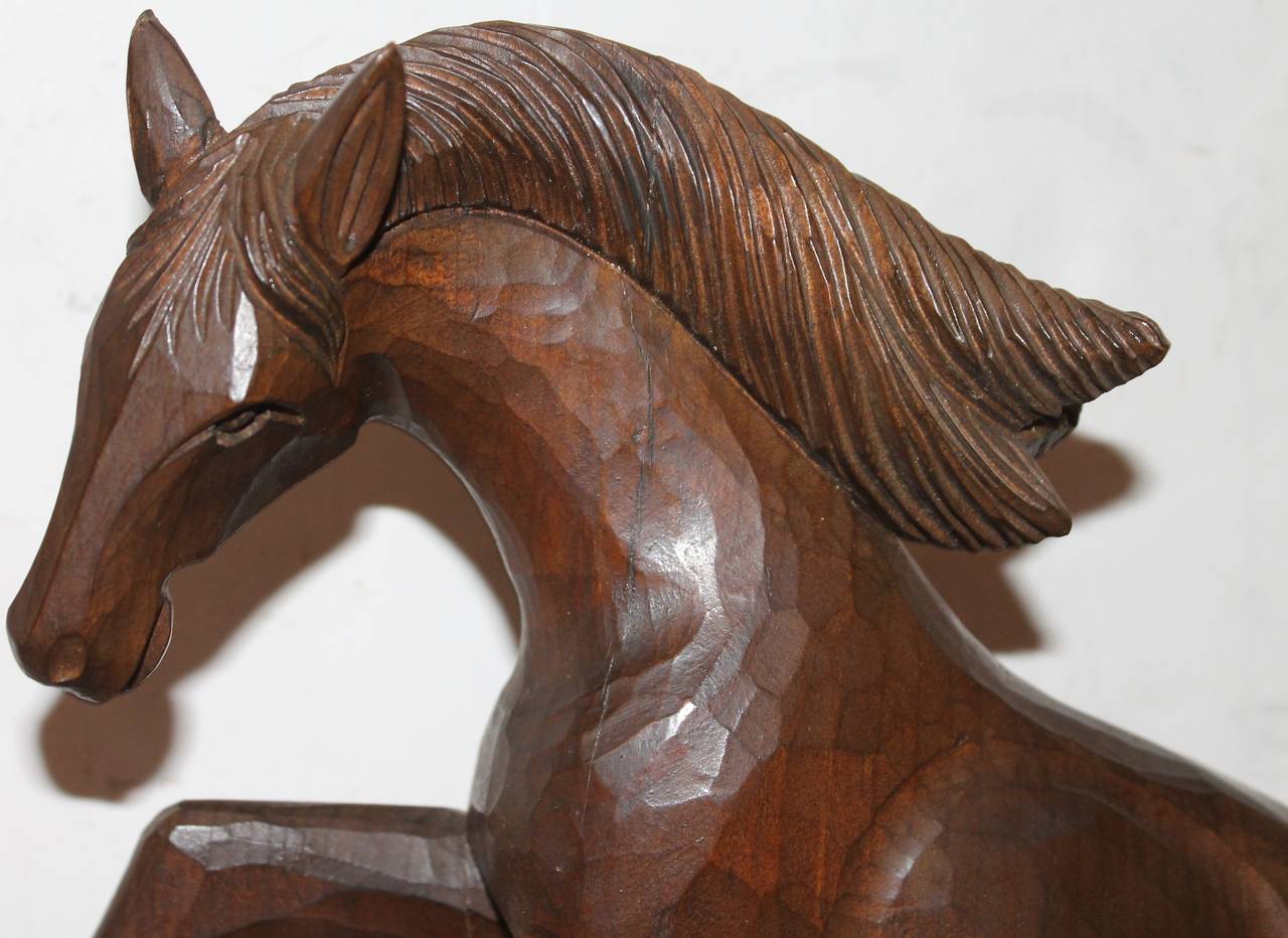 This wonderful hand-carved horse is riding and performing tricks. The Folk Art carving is unsigned. The maker is unknown.