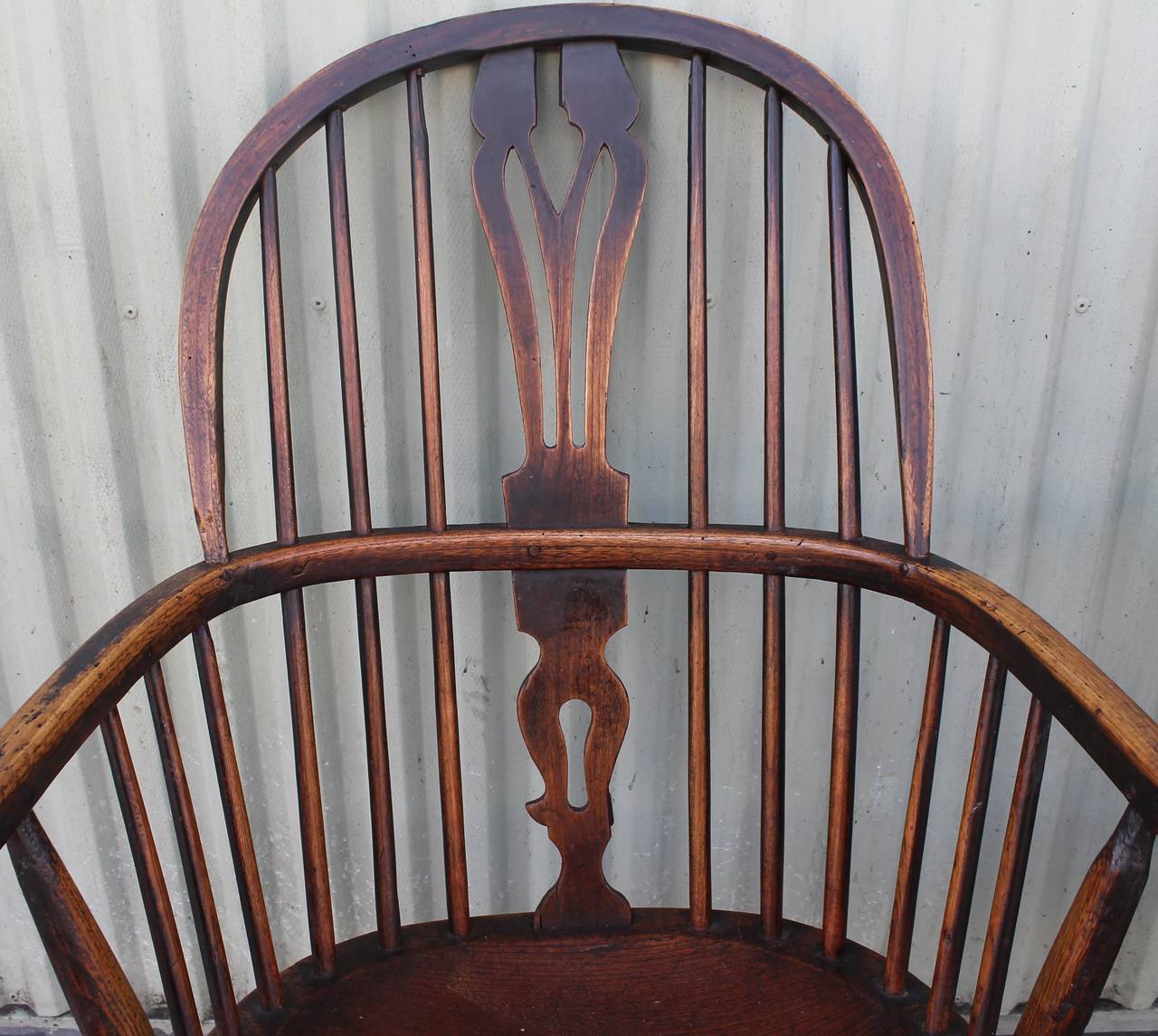This pair of  Windsor chairs are in fantastic worn condition. They  are not a exact pair as one is shorter in height. They are made by the same hand and have all the same characteristics of each other. The worn comfortable feeling is what make them