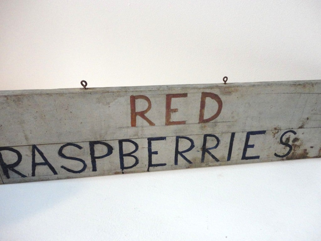 Early and folky red rasberries farm sign in red,white and blue paint.This sign was found in the state of Vermont .The sign has a wonderful old surface.The condition is great and is one sided.