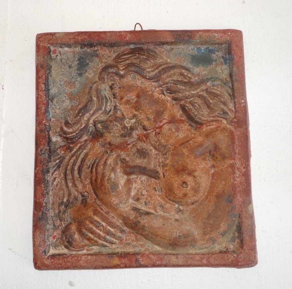 Wonderful 19th century original painted terracotta plaque with a great old patina. This wonderful piece of art has a Fine hairline crack through the middle that has been professionally glue and repaired. This wild lady has one breast out and is