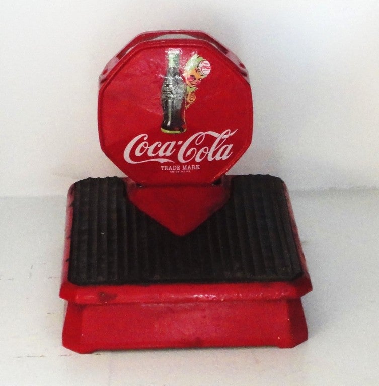 Fantastic cast iron coca-cola in red paint with original advertising label and rubber top mat. This wonderful folky scale works and is in great condition. This is quite rare and in great working order.