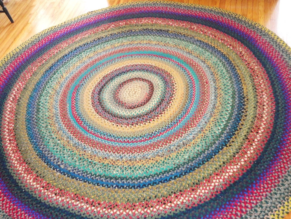 Wool round braided rug from the 1930's in colorful and somber colors.This handmade Pennsylvania braided rug is in great condition.