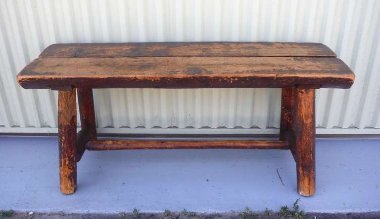 This early 20thc worn and sturdy rustic hickory style pine side table or coffee table is in great condition .This looks like it belongs on the ranch and has a great mellow patina . This split log top and rustic log frame is in wonderful as found