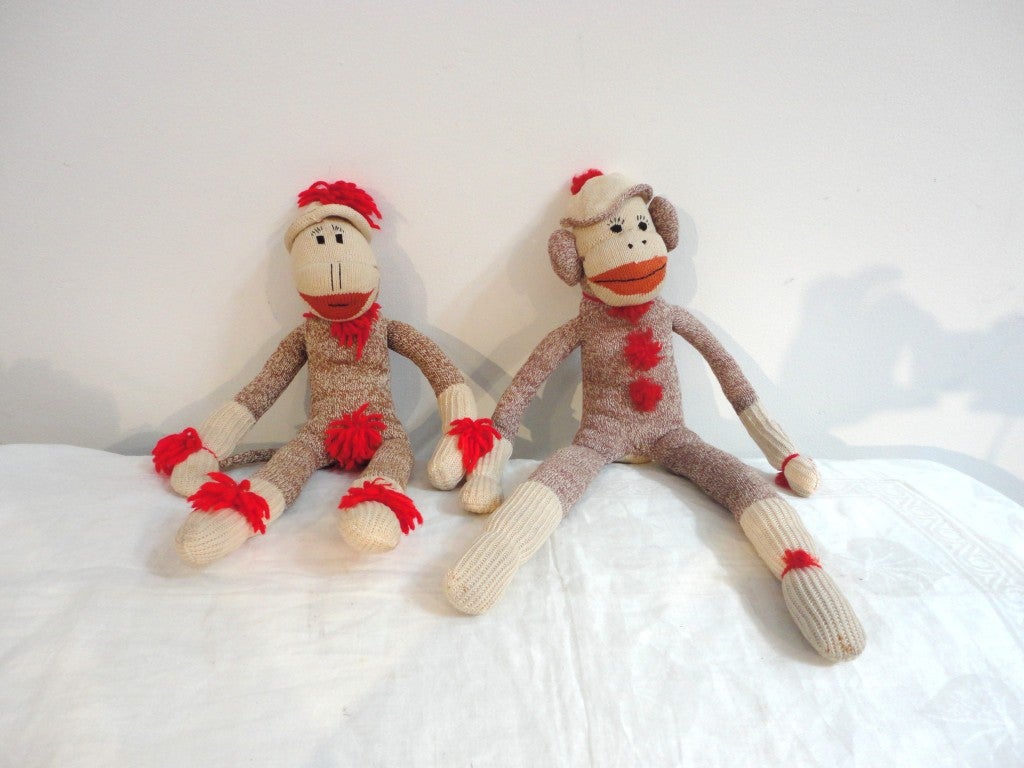 Fantastic pair of folky sock monkeys both wearing funky hats. Both are in great condition and are from a collection of wild folk art bears & dolls. Great in a chair or on a shelf.
