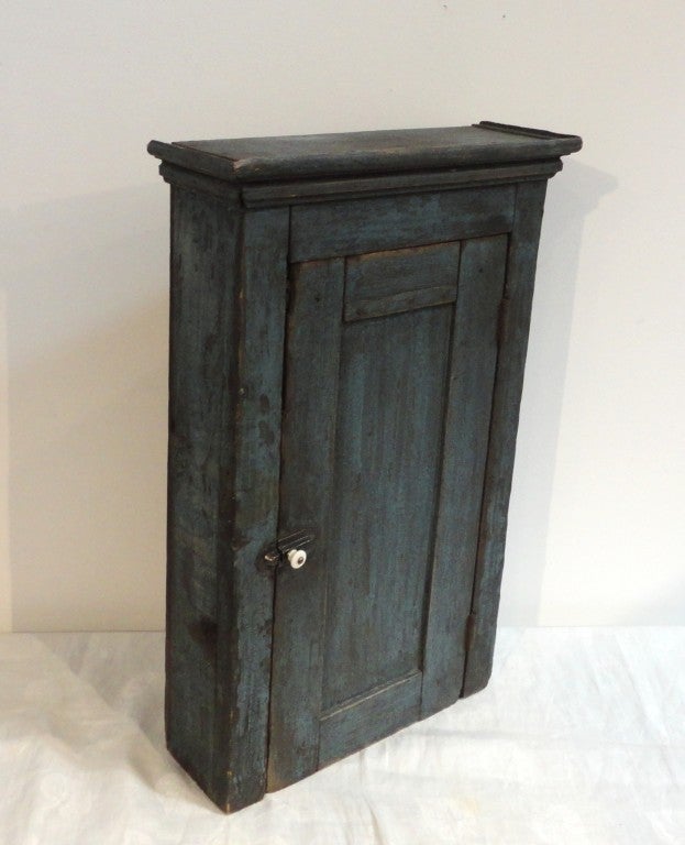 Fantastic original blue over blue 19thc hanging wall cupboard from Paducaha ,Kentucky .This wonderful country cupboard has the original iron hardware & hinges.There is one shelf in the interior and a wonderful crown molding through out the top.The