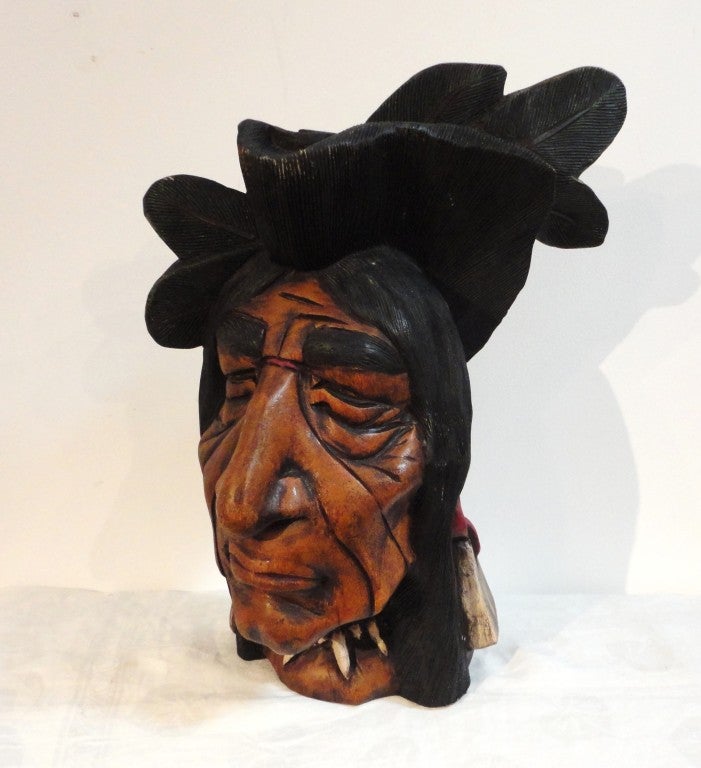 19th century hand-carved and painted cigar store Indian head. This size head was used in the windows or store counters in the cigar shop. The heads are a little harder to find then the full body cigar store Indian. The face has been repainted or