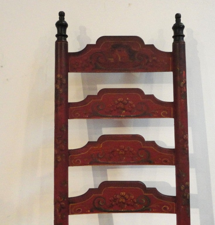 19thc Original painted tall ladder back chair with painted floral decoration and pin stripping.The top ladder back slat has a painted farmhouse on it.The back,sides and the front of the chair has the floral decoration throughout. The finals at the