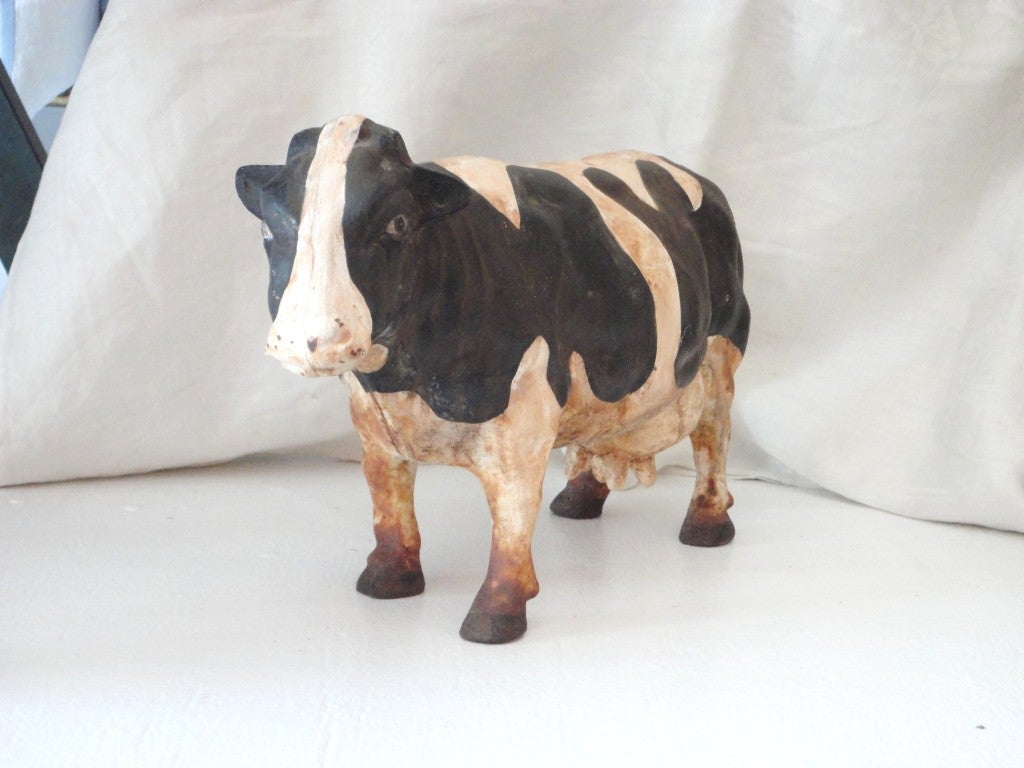 Folky full body cow doorstop in original painted surface.This cast iron baby is very heavy and in great condition.This girl is a full body girl.