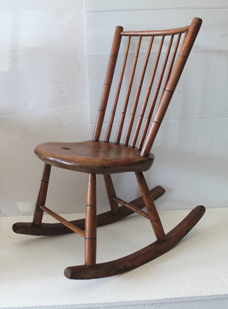 This fine hand made and carved  19Th c. rocker was found in Pennsylvania and is in wonderful as found condition.This fire side rocker was probably used for a child or as a nursing rocker.Perhaps she made quilts and worked on textiles in this