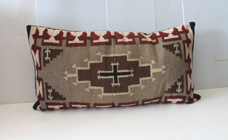 This is one of two fantastic Navajo Indian saddle blanket  Weaving's that was made in to a bolster pillow.The condition are very good.The backing is a dark brown cotton linen .