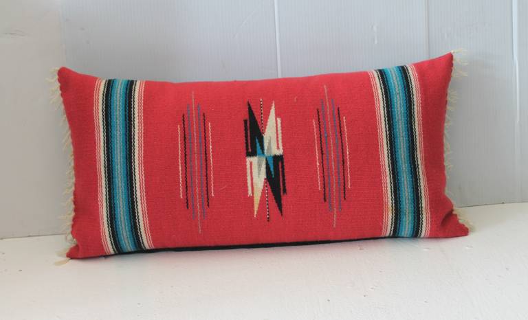 This vibrant red ground Mexican or American Indian weaving has bold colors and in great condition. The backing is in a black cotton linen and down and feather fill.