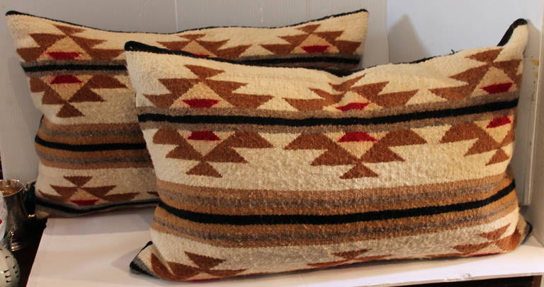 This is a great pair of geometric Navajo weaving pillows in a flying geese pattern. The condition is very good with cotton linen backings. Sold as a pair. The inserts are down and feather fill.