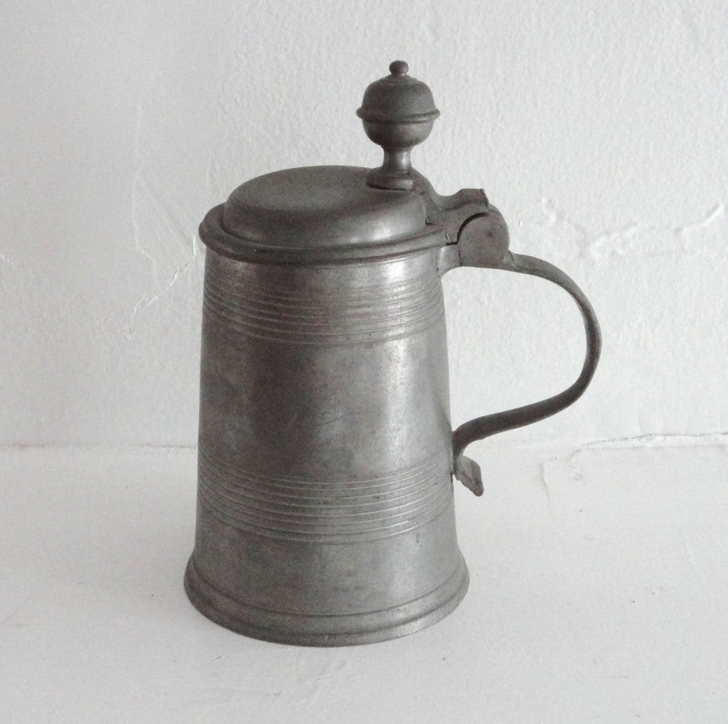 Fantastic 19thc pewter tankard in wonderful workmanship and condition.This heavy & simple form lidded tankard has a wonderful ball  on the top for opening and closing.