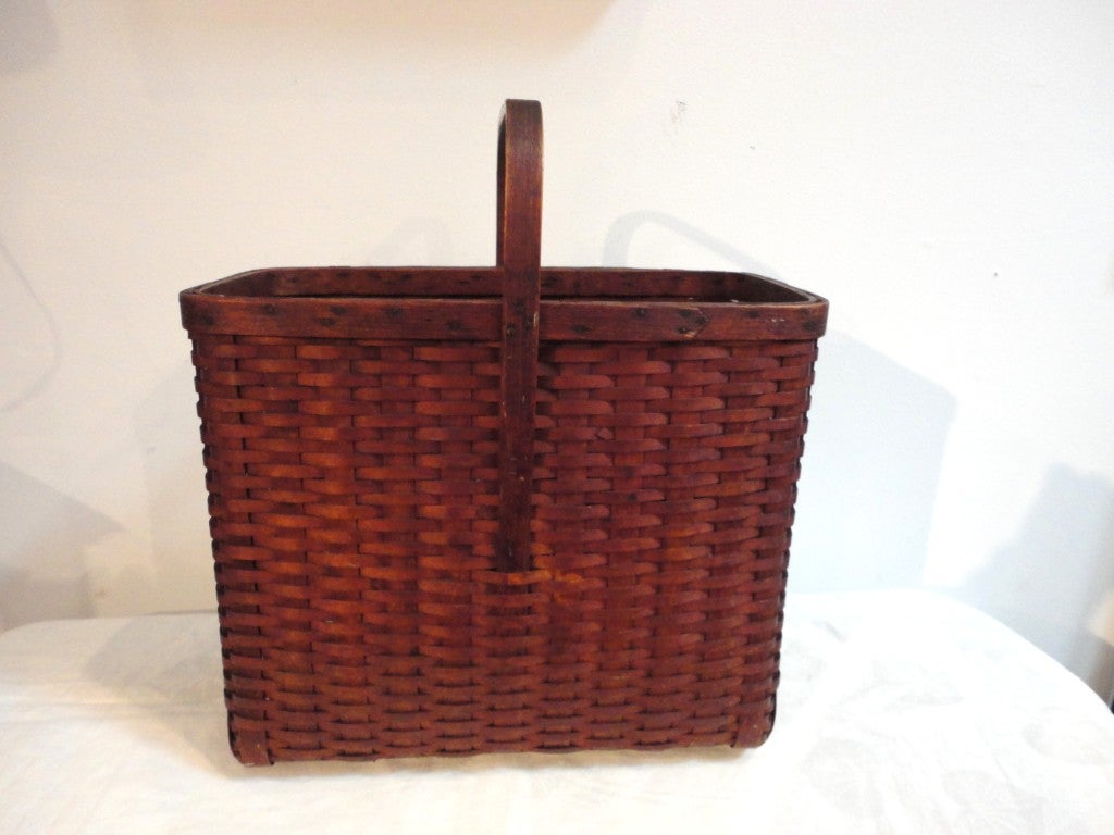 Amazing 19thc Shaker style picnic basket from New England .This tall basket is in great condition and has wood runners on the base for extra durability.Great for magazines or storage.