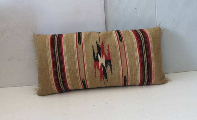 This neutral tan background Indian weaving is in wonderful condition and made a great statement as a bolster pillow. The backing is in tan cotton linen backing. Insert is down and feather fill.