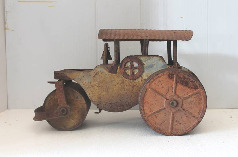 This model tin and iron signed Keystone steam roller from Boston, Mass. was found in the state of Maine. It has a wonderful worn painted original as found patina. This toy is in order. Great piece of American folk art for a wall shelf or bar. In