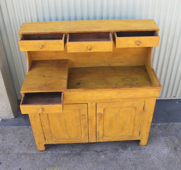 19Th century amazing chrome yellow or bright mustard painted high back most unusual form dry sink . This high back sink works well for a server or  buffet . There are four drawers of which are all original and square nail construction . The base or