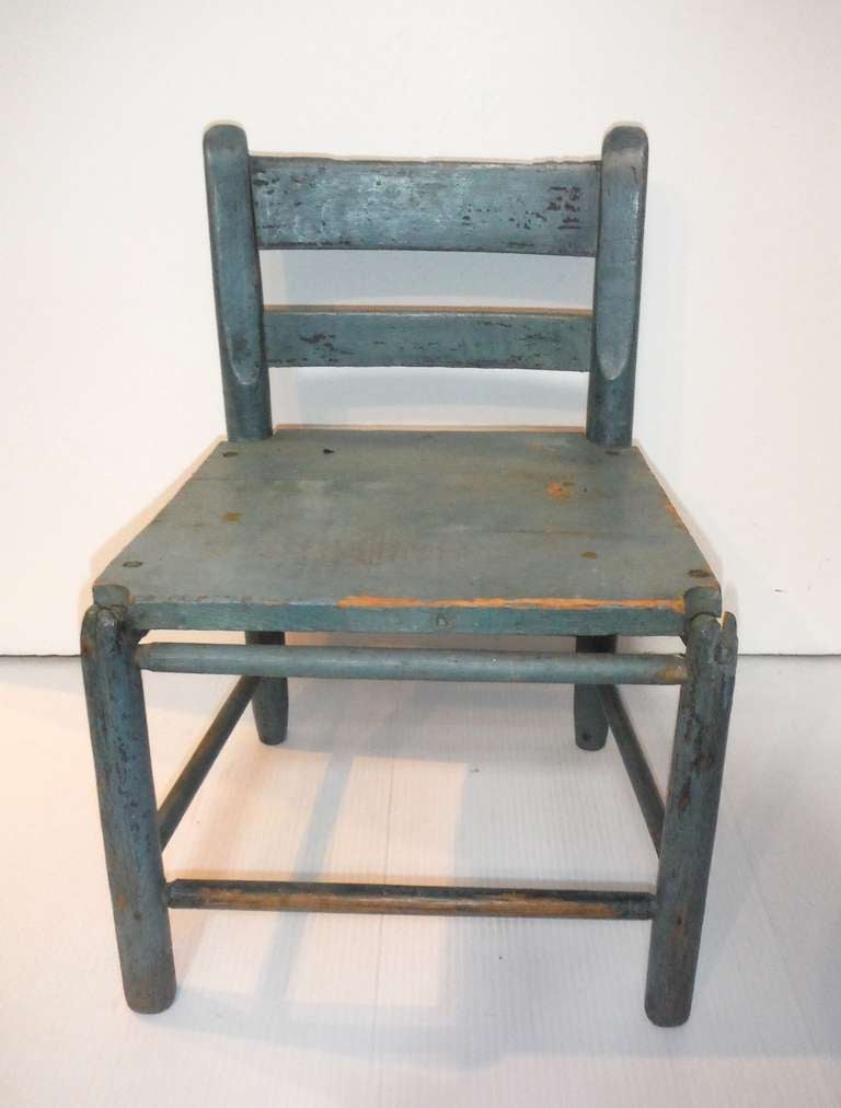 This wide seat 19thc robin egg blue child's ladder back chair is in undisturbed surface and in very sturdy condition. This chair was found in New England . The patina is the best.