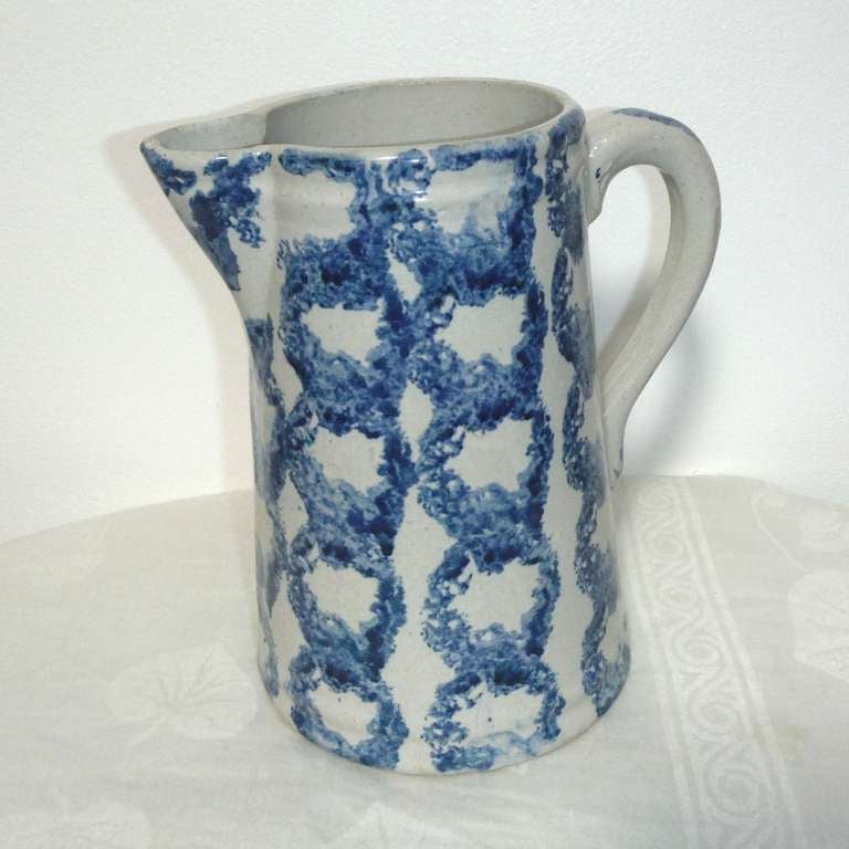 Fantastic 19th century original decorated spongeware pitcher with a circular rows pattern. The condition is very good.