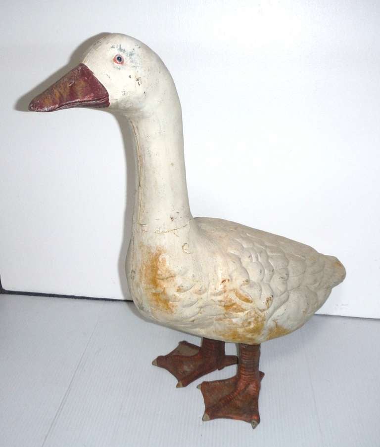 This hollow body, very large cast iron painted duck was found in the mid west and has a great worn patina. These ducks or chickens were usually lawn ornaments or found on a farm .The entire body is in iron as well as the orange painted feet . The