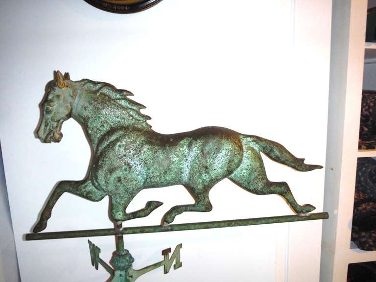 This monumental and well conserved 19th c. New England weathervane shows a full-bodied, running Dexter Horse hand-constructed with a cast-iron head, molded ears, eyes and mouth.  Rich character is exemplified by hand solder marks fusing the