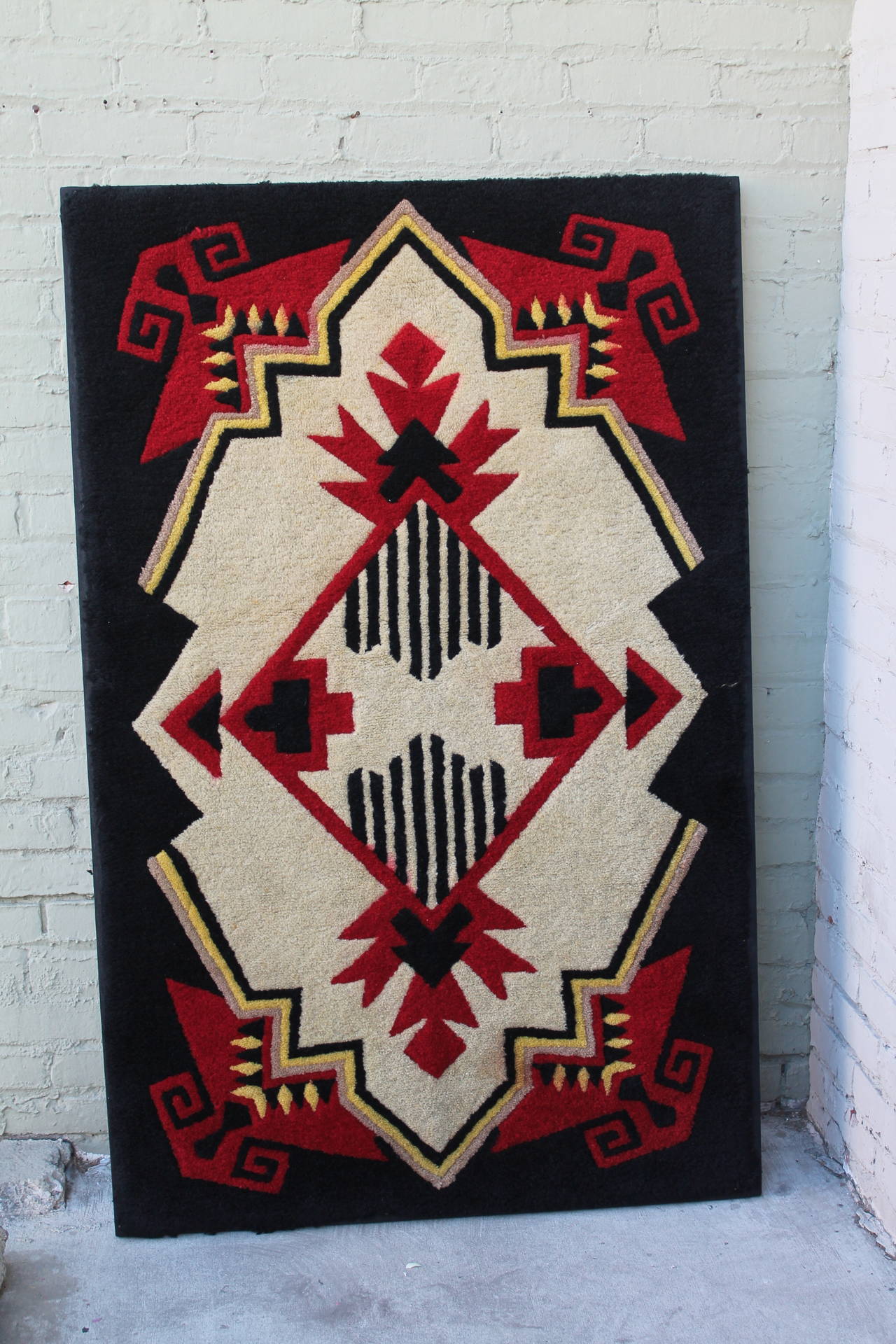 1930s mounted geometric hand hooked rug. Berlin work, embroidery style. Professionally sewn on linen and mounted on stretcher frame. Geometric with a little Native American appeal or look.