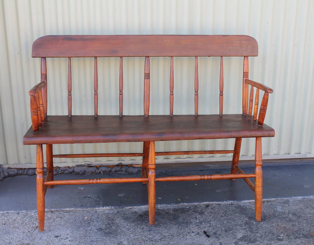 19th century pine settle bench or loveseat from New England. This plank seat has a wonderful worn patina. This sturdy bench is in great untouched condition and has a wonderful look.