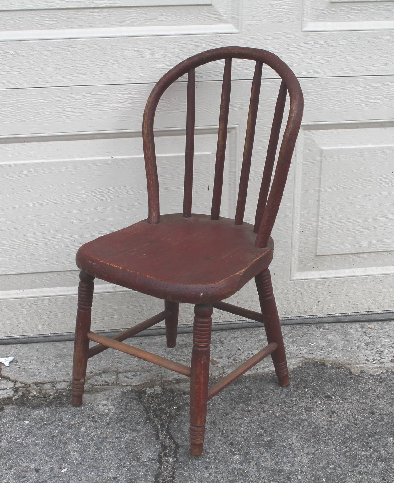 This hoop back child's chair has a wonderful original red crackle surface. This small windsor or plank bottom is in as found sturdy condition. Great for your child during the holidays and there after. This chair was found and made in Pennsylvania.