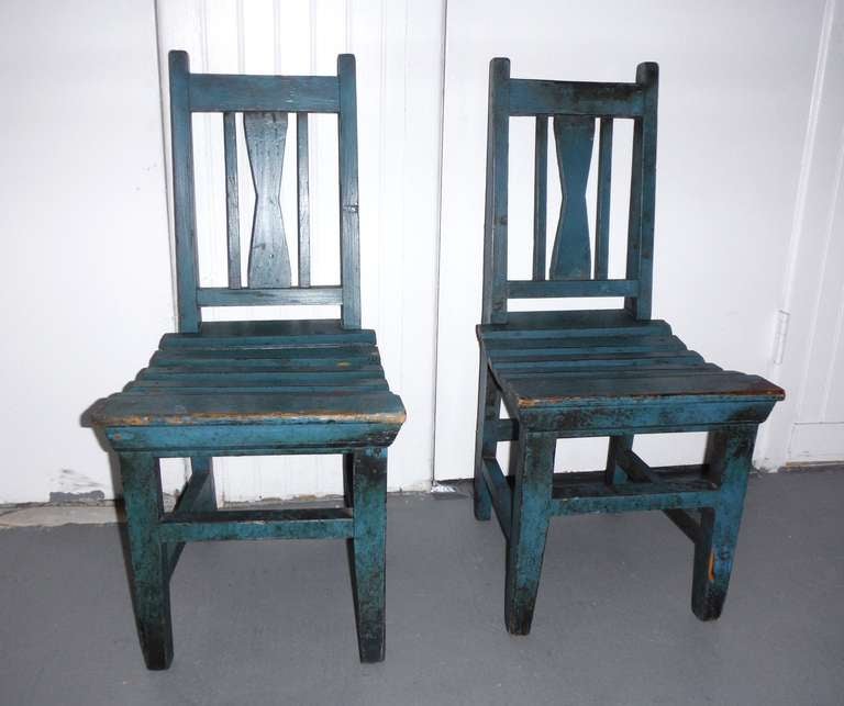 This fantastic hand made original blue painted children's chairs have a wonderful old patina and are in sturdy condition . The form is most unusual and the chairs are mortised construction . They are made of pine wood and have slight wear from use