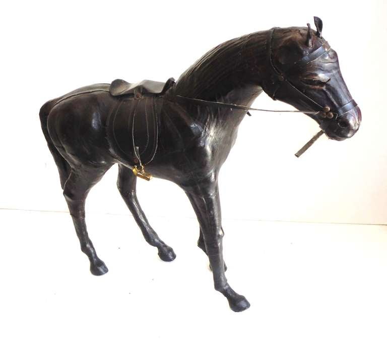 brass horse statue with saddle