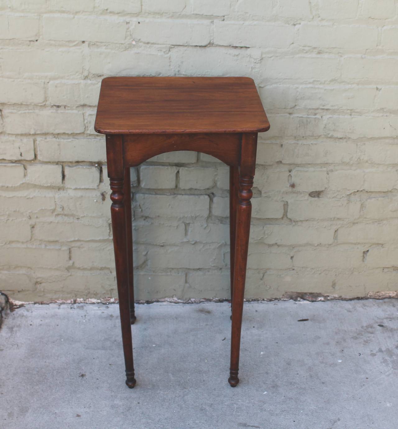 This finely made early turned leg stand has a wonderful original patina and is in very sturdy condition. The table has all of its original wood blocks underneath. It is simple yet amazing condition and surface.