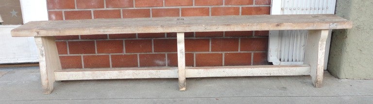 19thc original white painted plank wood farm bench from Pennsylvania.This thick two inch plank bench has dovetailed and mortised construction through the top of the seat.The condition is very good and sturdy too.