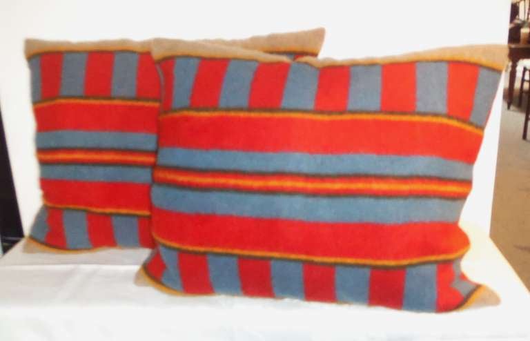Red & blue 18thc  wool horse blanket pillows with a orange trim  stripe border .Sold as a pair . The backing are in tan cotton linen .Sold as a pair .