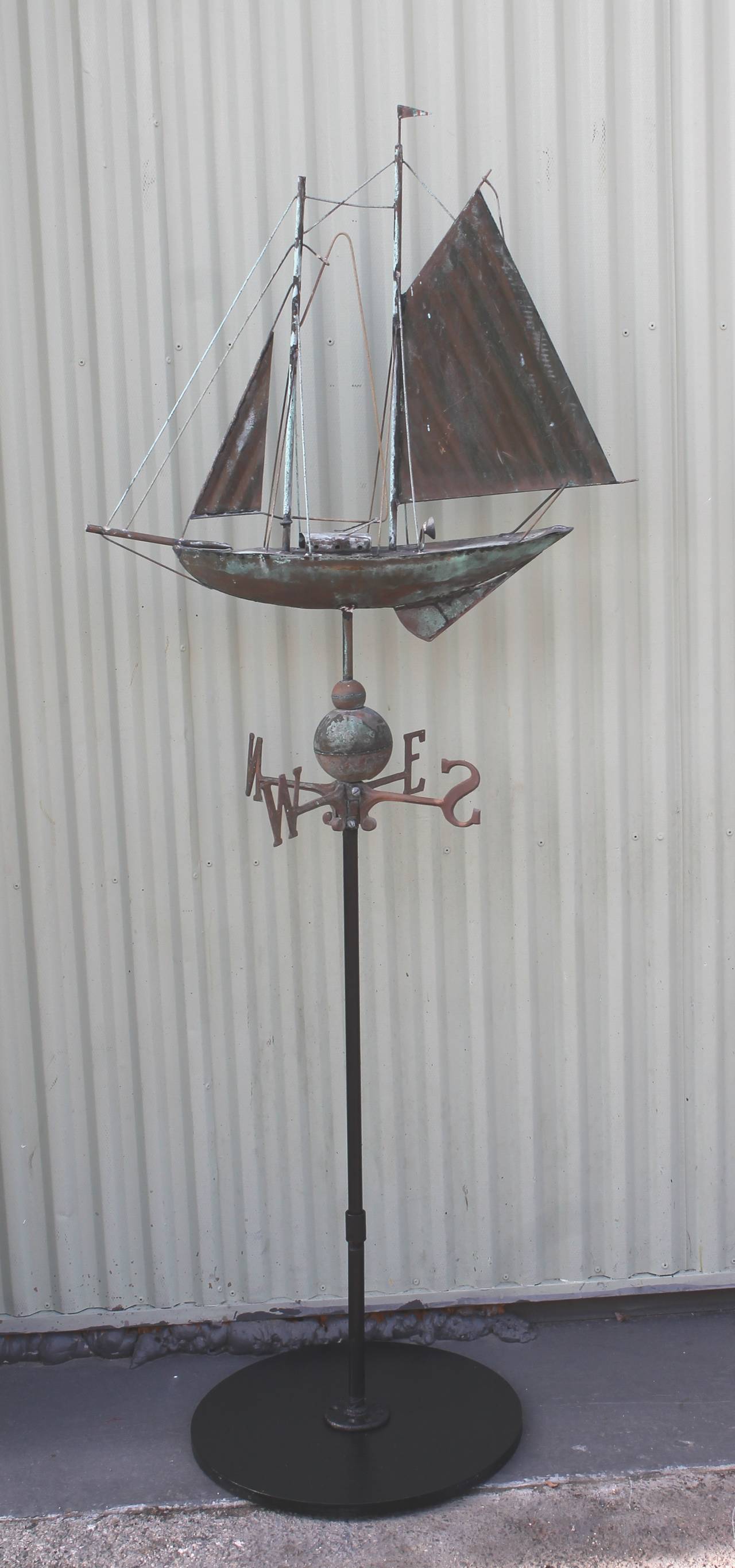 This full body copper sailboat weathervane is on a removable stand. This vane was found in New England and has a wonderful untouched vertigres surface. It also retains its original Directional. This is a handmade vane. The condition is very good