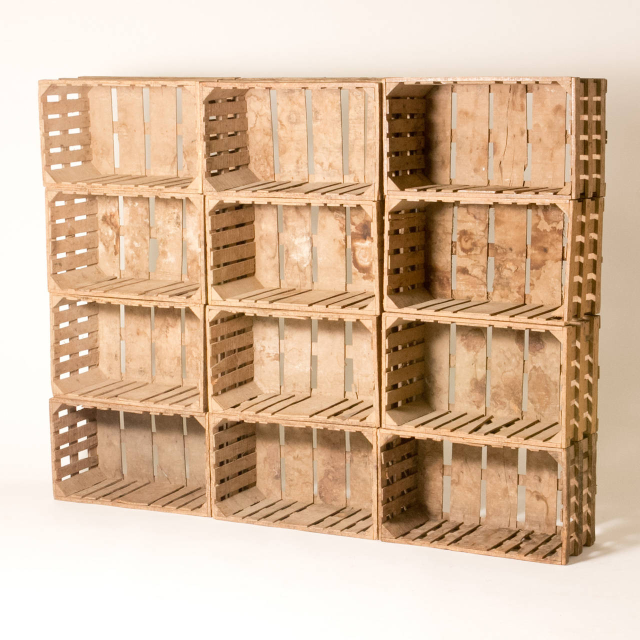 Bookcase made out of twelve blonde, exposed wood crates from early 20th-century France. With a wonderful patina and a raw, industrial sensibility, the crates provide a unique way to store and display books and objects. Can be purchased in multiples