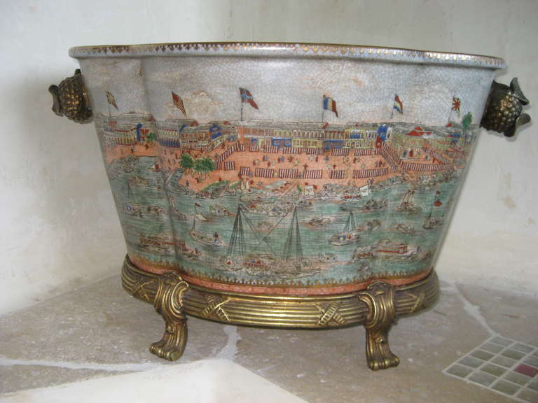 In the style of a large Chinese export footbath with Chinese export themed decoration and bronze base with bronze fruit handles.  This is about 25 years old and is excellent for a center piece or planter.