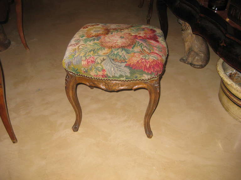 Louis XV manner carved stool with antique tapestry textile
