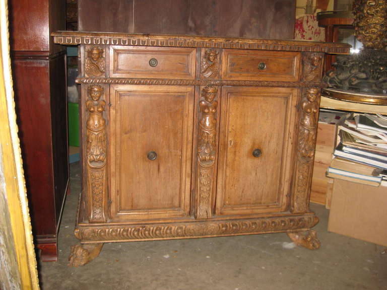 18th Century Italian two door two drawer cabinet with beautiful carved features.   This is as found and needs waxing and restoration to the thick top which has lifted in the back ..see images