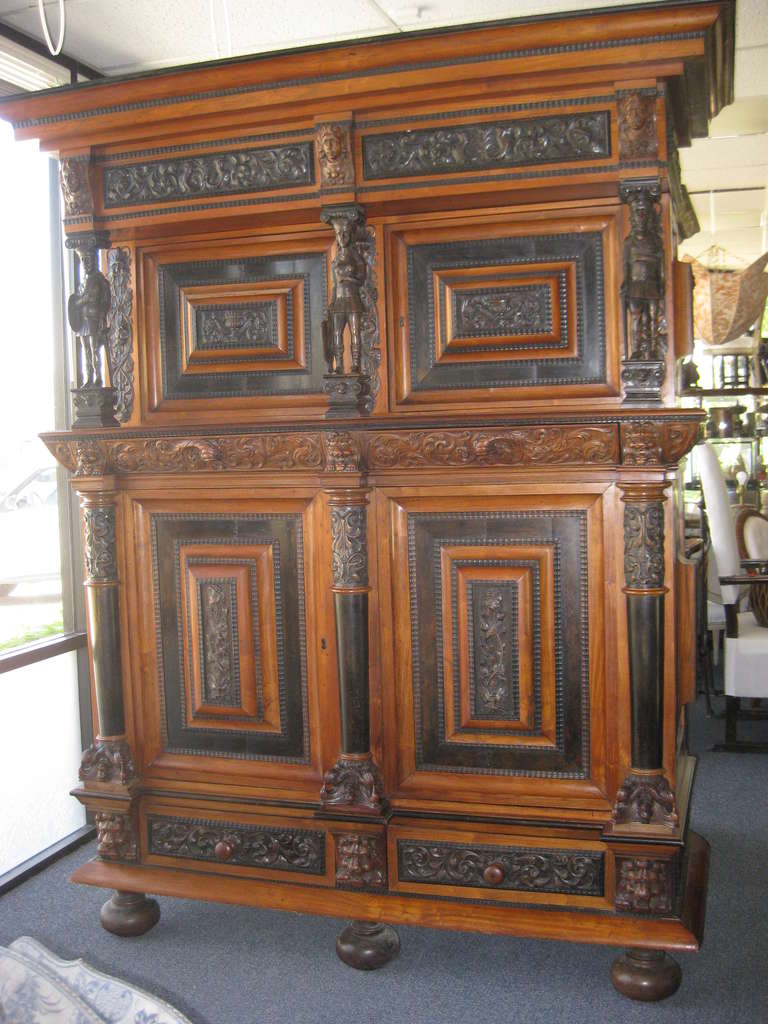 Large impressive Dutch cabinet most likely not of the period but 19th century with 17th century elements. Beautiful carving and ebonized sections and two fitted lined trays in the bottom drawers. The depth is 31