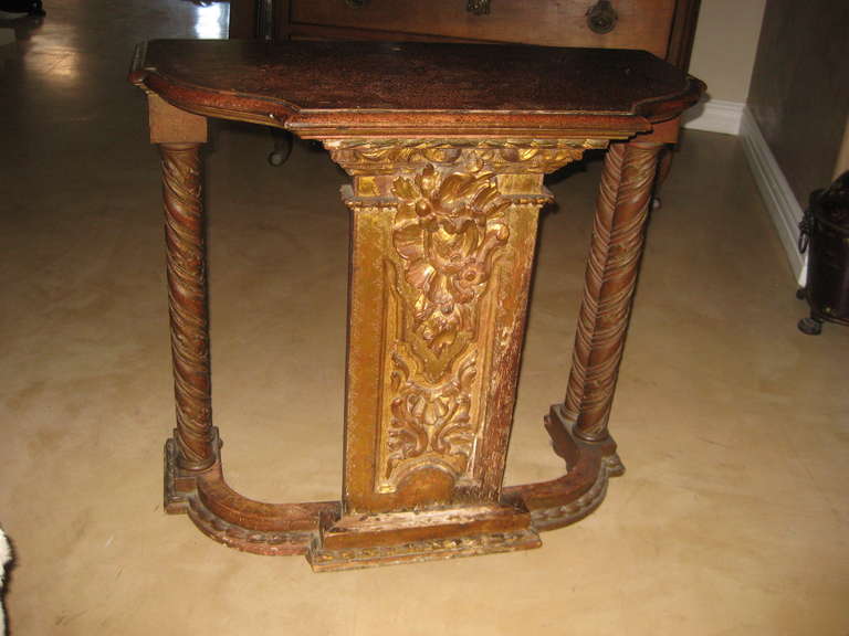 Great looking small scale console table perfect for a hall or powder room.This has a painted top and beautiful carved gilt wood center panel and carved turned side posts. Composed of 18th century elements.