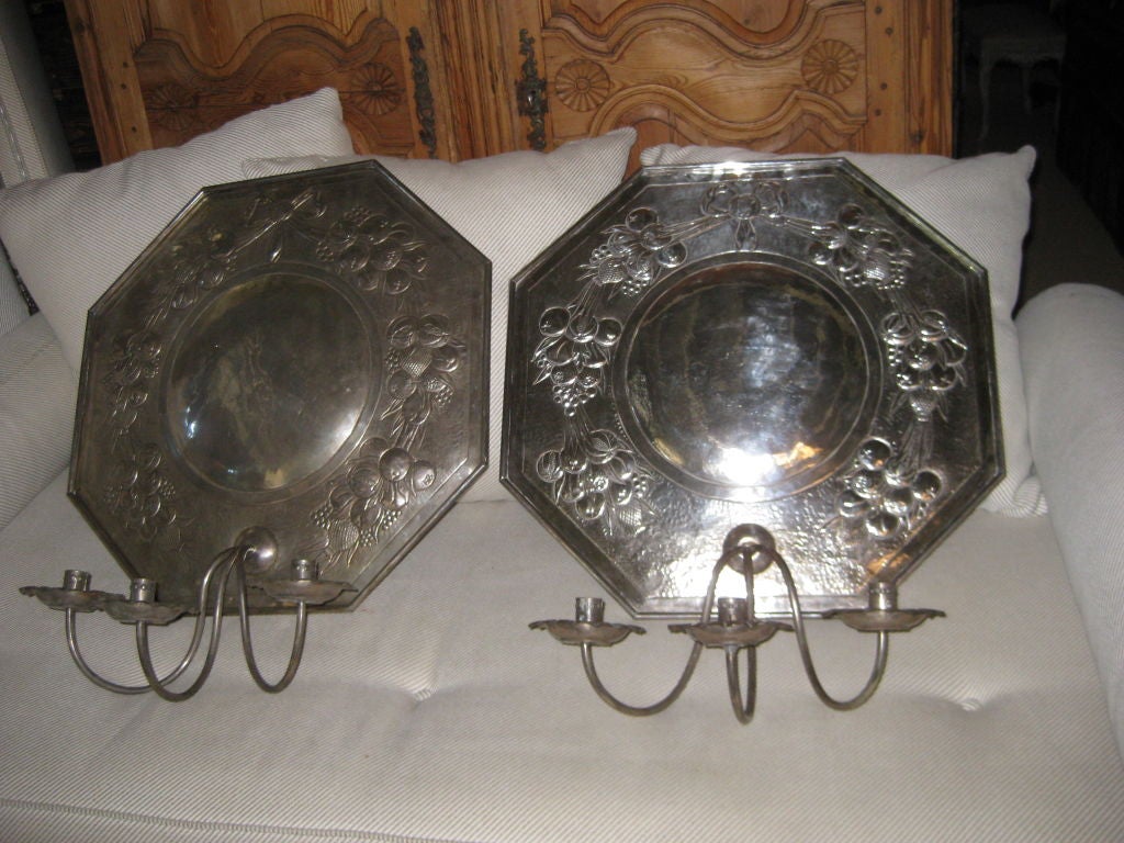silvered brass with repouse worked surfaces and silvered finish  each one has three candle holders and can be wired but are not.  These have some age.  Look at the last images for how they are shined up