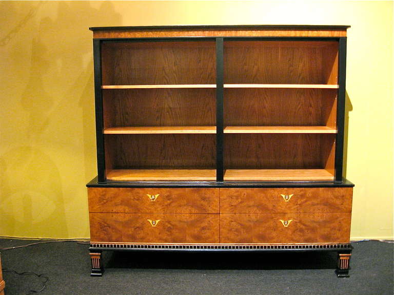 Swedish art deco/neo classical storage bookcase in elm and carpathian elm with inlaid ivory. Designed by Gustav Bergstrom circa 1920. There are four carpathian elm covered drawers. The interior has four removable/adjustable shelves.

The price