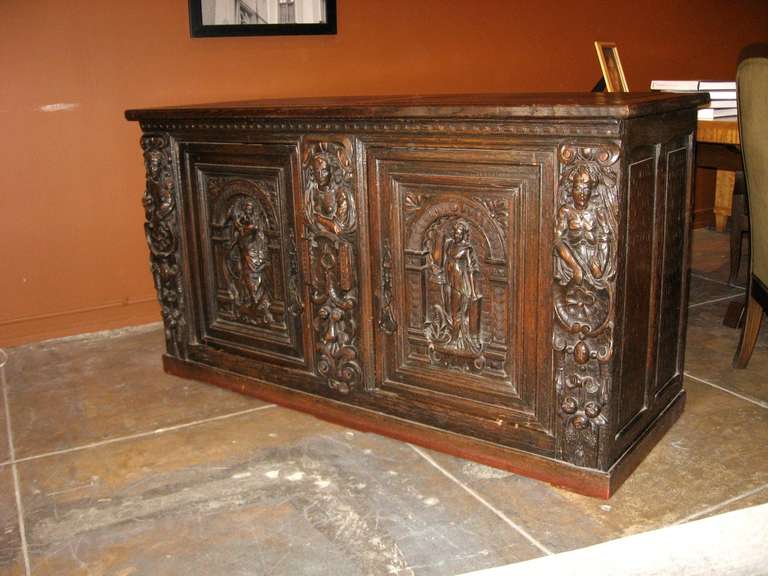 18th Century Spanish figural carved chest in walnut.
All hand carved and hand forged metal work.
Keys to original locks are missing. In good period condition. 
With patina, scratches and dings which do not detact from it's period beauty.

The