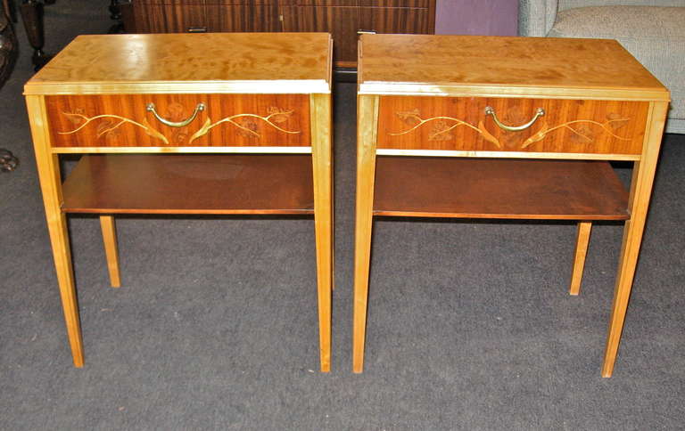 Pair of Swedish mid-century modern end tables/night stands by Svenska Mobelfabriken. Tables are composed of highly figured golden flame birch. Neo-classical inlay on drawers is in rosweood, carpathian elm and satin wood. These are in excellent